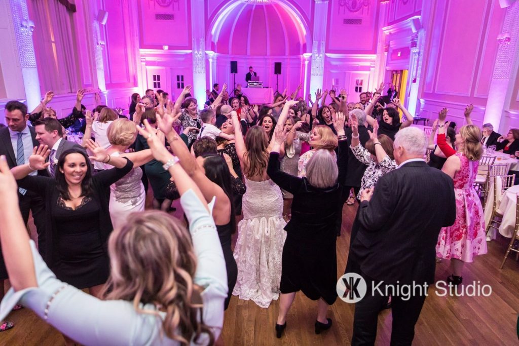 bride dancing in a crowd during her reception | Buffalo wedding DJ
